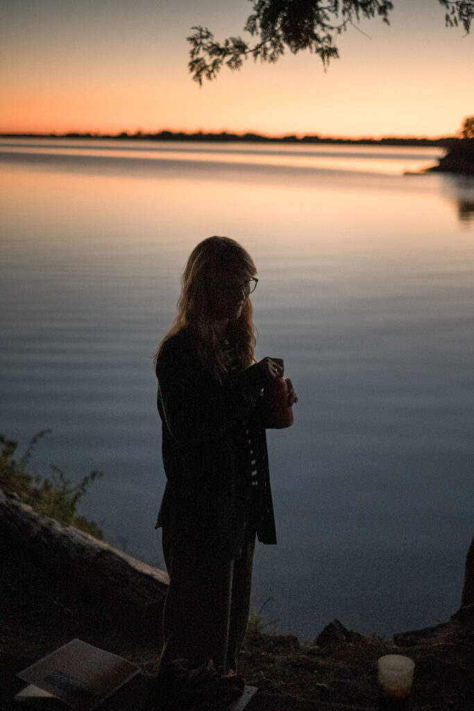 silhouette of Lauren Jane Heller in front of the sunset on a lake